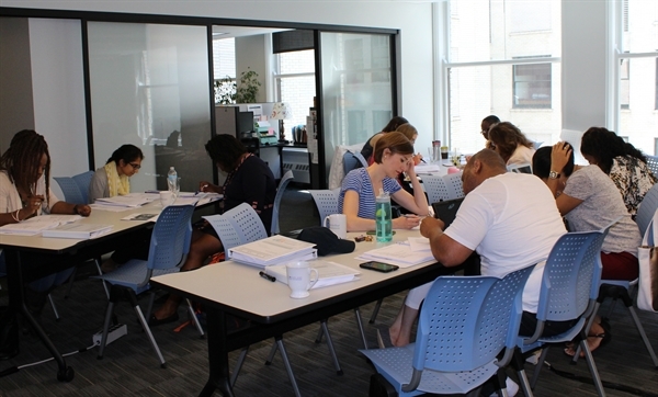 Students sitting at tables working on a class activity